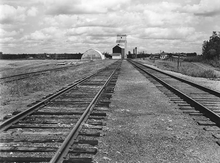 Grain elevator, service structure and railway station at a prairie railway stop