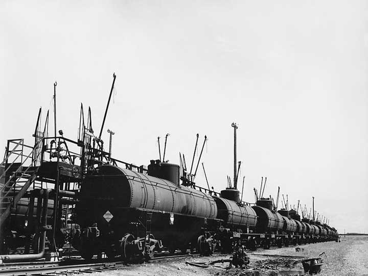 Oil tanker cars line up at a prairie oil refinery