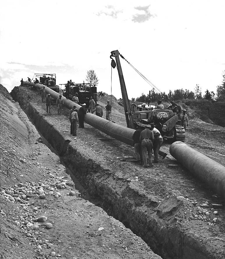 A segment of pipe is lifted into place