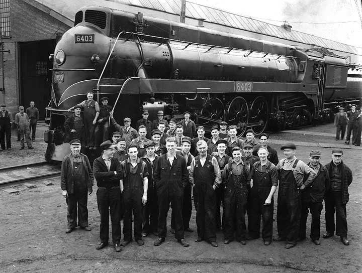 Railway workers pose near Canadian National Railways steam locomotive no. 6403 during the 1939 Royal Tour of Canada