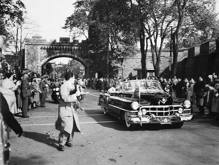 The car carrying Princess Elizabeth and the duke of Edinburgh passes through the St-Louis Gate in the old walled city of Québec