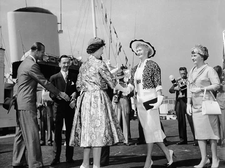 Queen Elizabeth and Prince Philip are received by dignitaries after disembarking from the HM Yacht Britannia during the 1959 Royal Tour