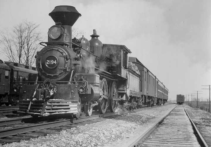 Grand Trunk Railway steam locomotive no. 2194 hauls a passenger train; note the newly-installed smoke stack