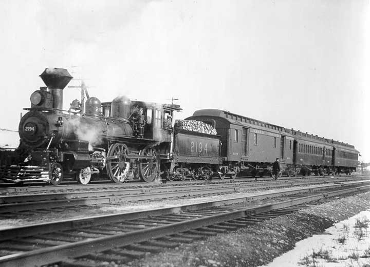 A Grand Trunk Railway passenger train hauled by wood burning steam locomotive no. 2194