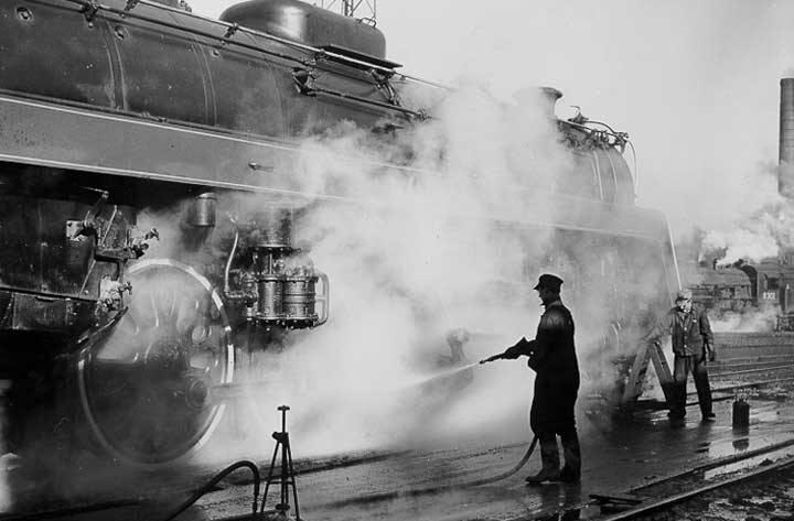 Canadian National Railway workers cleaning a locomotive