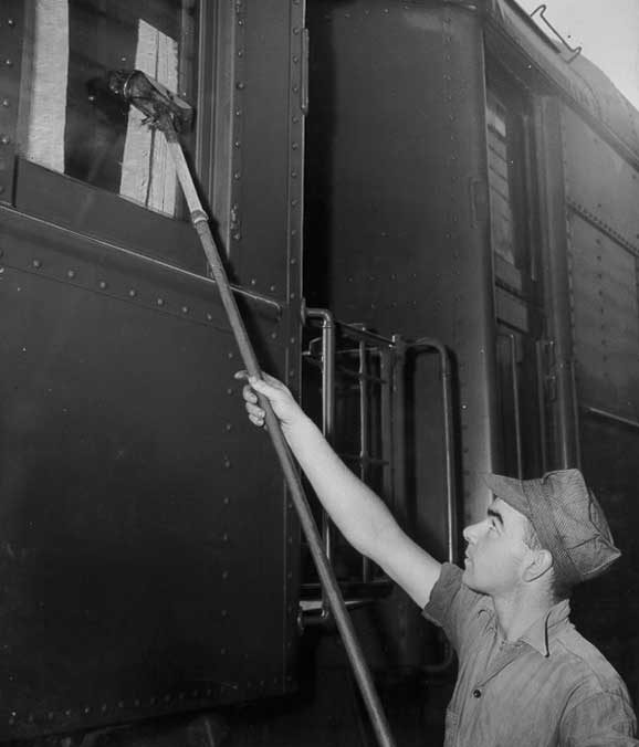 Canadian National Railways employee cleaning a passenger car