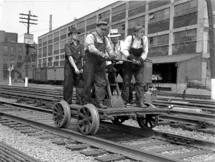 Sectionmen, on pump handcar, working on the main line at Turcot yard