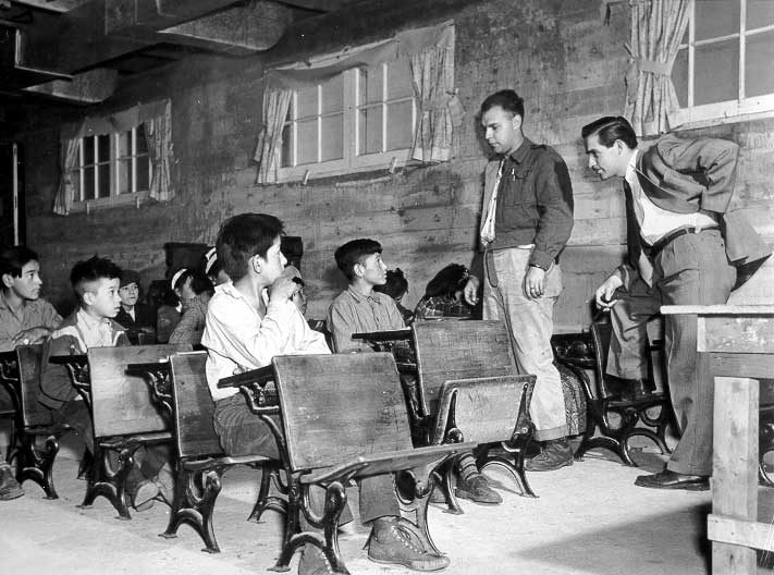Dr. Mclean, right, with teacher Bob Ross, speaking to Aboriginal children who are eligible for dental treatment