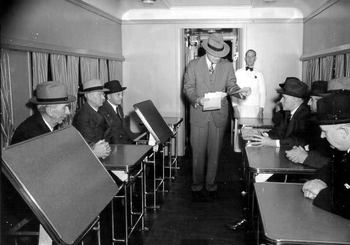 Directors and newspaper staff awaiting lunch in the dining car