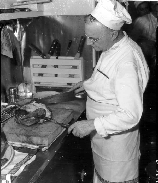 Carving chicken in the kitchen of the dining car