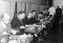 Directors and newspaper staff having lunch in the dining car