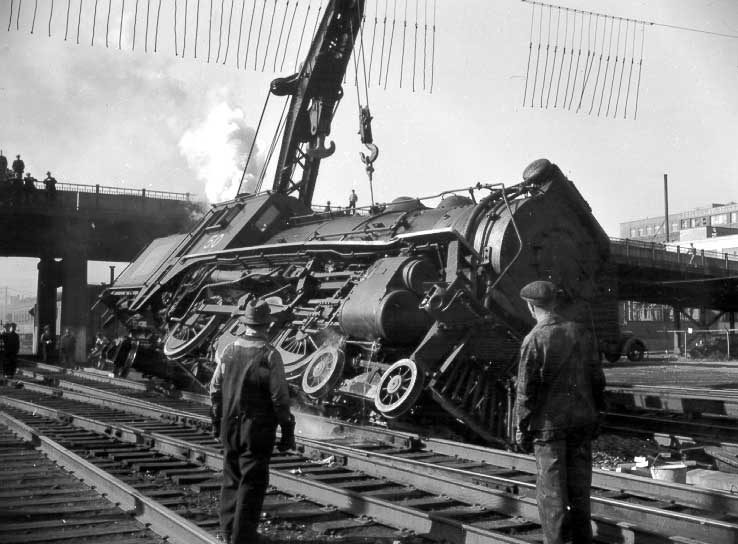 Steam locomotive 50 being replaced on track by CN employees after a collision, west of Bonaventure station