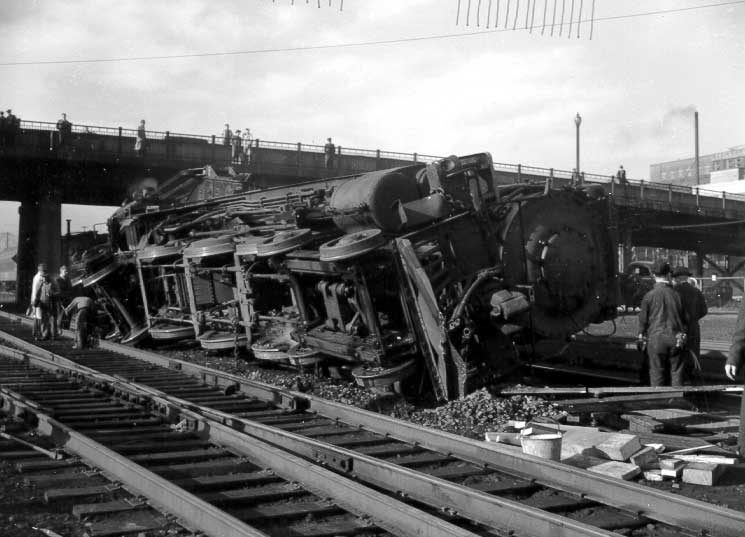 Steam locomotive 50 being replaced on track by CN employees after a collision, west of Bonaventure station