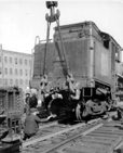 Steam locomotive 50 being replaced on track by CN employees after a collision, west of Bonaventure station