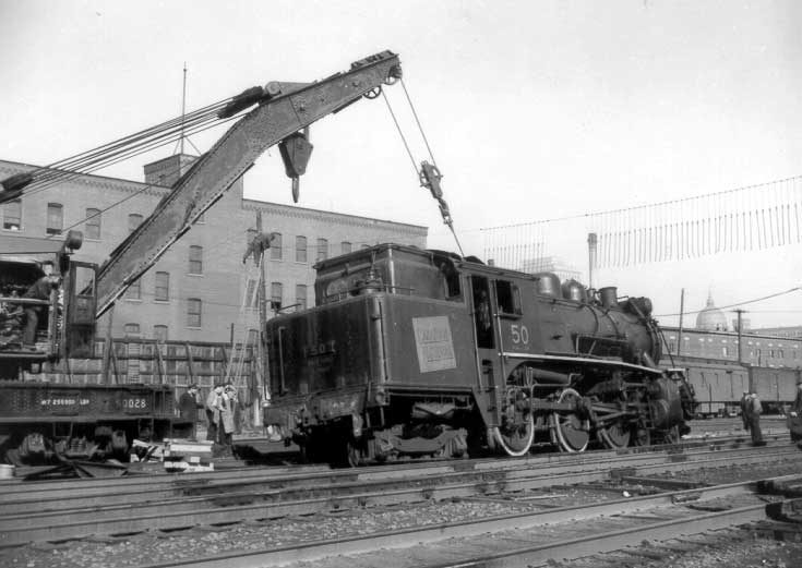 Steam locomotive 50 being replaced on track by CN employees after a collision, west of Bonaventure station