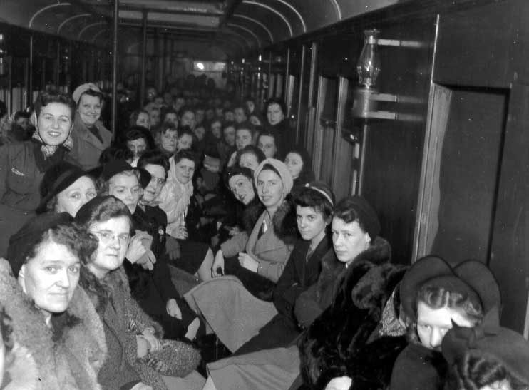 Full passenger train of employees on their way to work at the Cherrier Munitions Plant