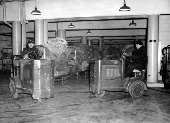 Central Station employees maneuvering Christmas mail