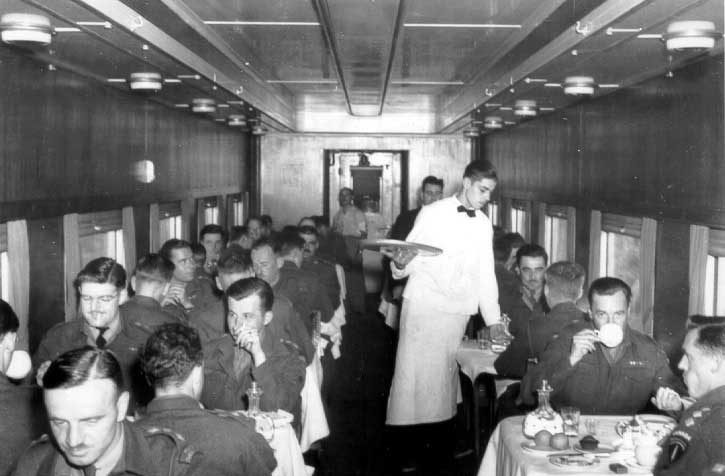 Servicemen enjoying a meal in the dining car