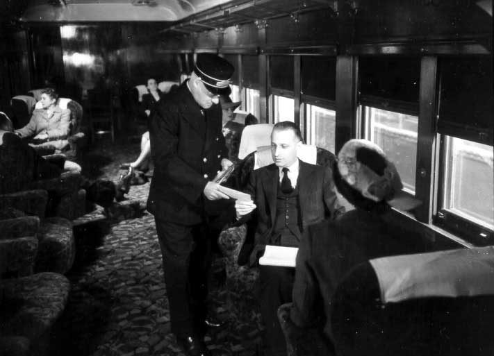 Train conductor delivering telegram to passenger