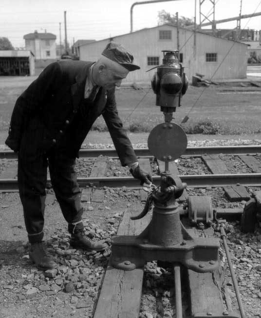 CN employee checking the lock on the track switch, Val Royal