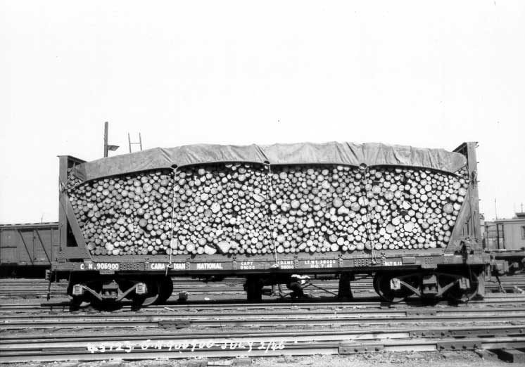 View of lumber car 906900 loaded with logs