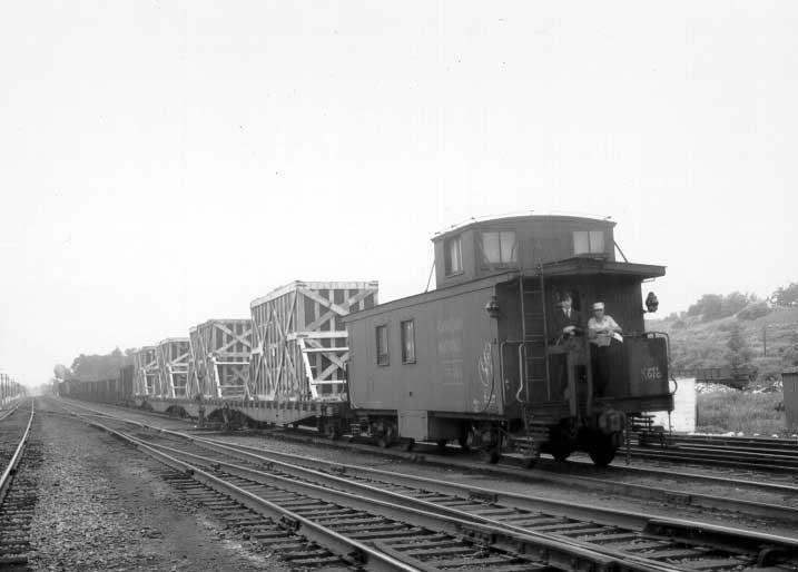 Freight shipment of prefabricated aluminum houses, in crates, leaving Turcot Yards enroute to Kingston, Ontario