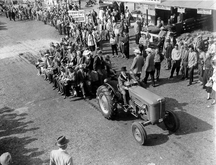 Individuals being pulled by a tractor at the International ploughing match