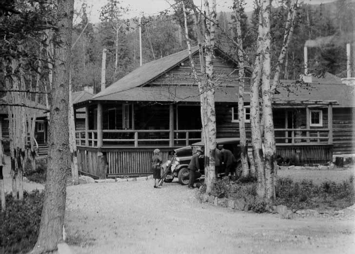 Guests outside their cottage, Douglas Lodge