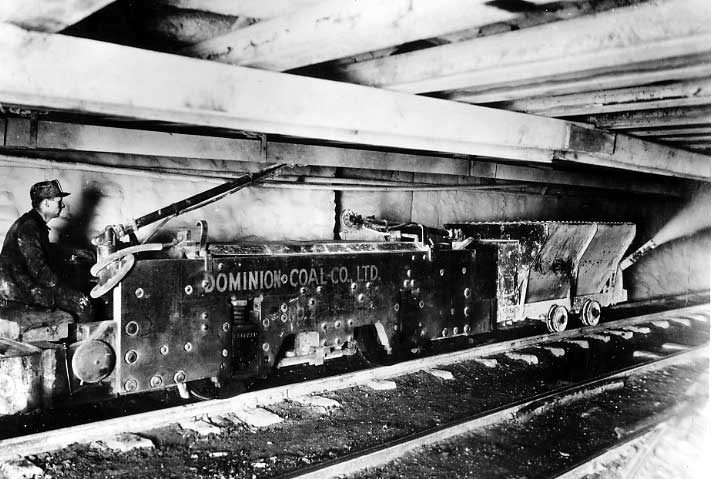 Electric locomotive showing stone dusting operation in main haulage tunnel