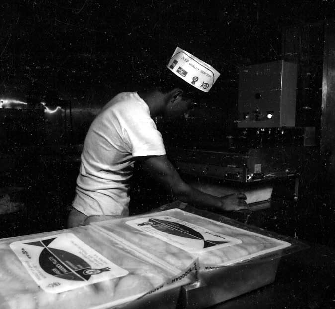An employee packaging boxes in the Sea Salad division of the fish processing plant
