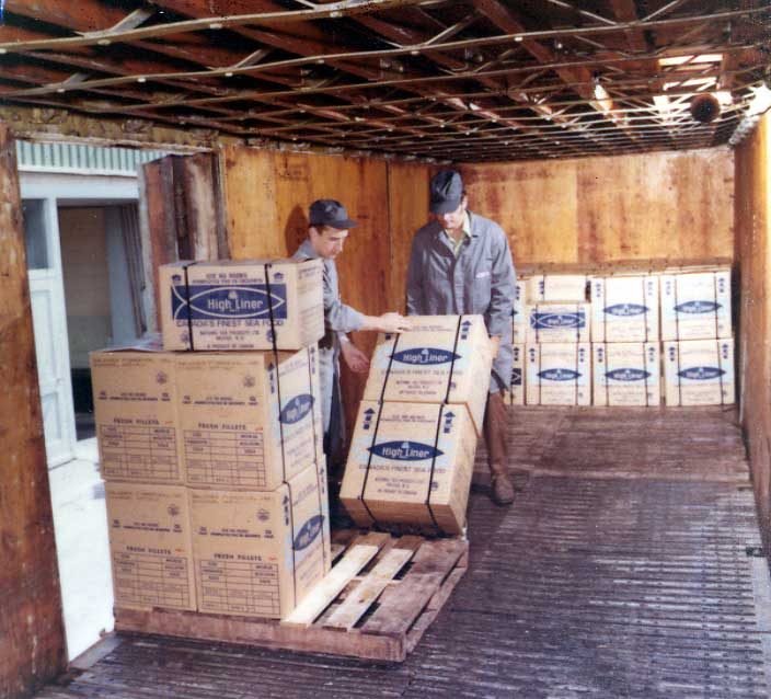 Refrigerated CN cars being loaded with fresh fish