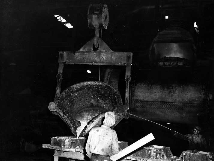 Pouring moulten metal into moulds