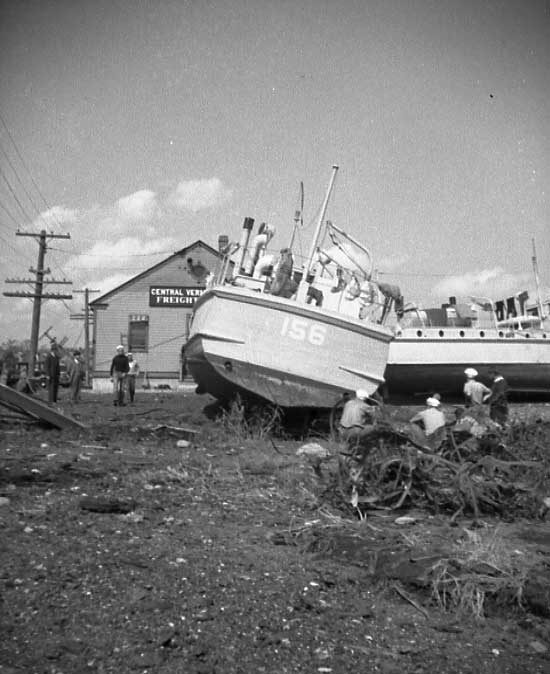Hurricane damage affecting the Central Vermont Railway docks at New London, Connecticut - grounded boats