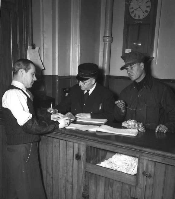 Central Vermont Railway train crew signing a register.