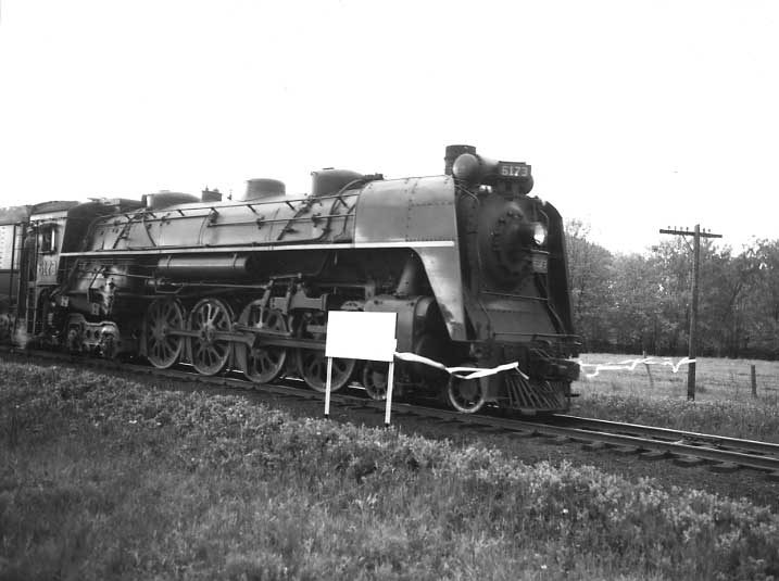 Central Vermont Railway passenger train The Montrealer breaks a ribbon at the U.S.A. / Canada border, celebrating 25 years of operation.  CN steam locomotive 6173.