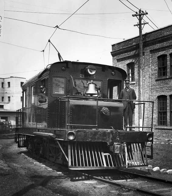 Montreal and Southern Counties Railway electric locomotive 325 alongside the Waterman Fountain Pen Co. facory.