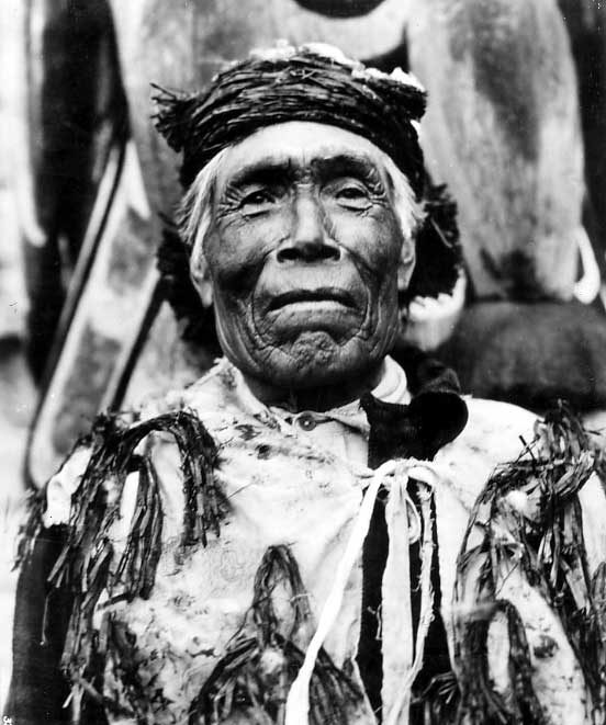 Aboriginal Elder wearing cedar bark headband and paisley vest with cedarbark tassles