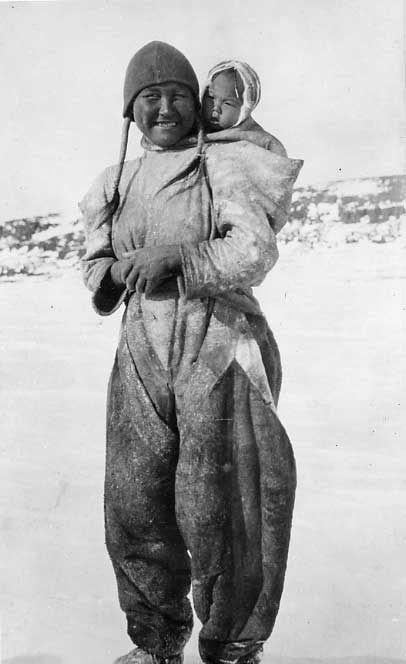 Inuk woman in skin clothing, with baby in amoutik.
Original caption: