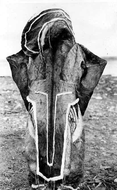 Back view of Inuk girl wearing decorative caribou skin clothing (fur facing out)