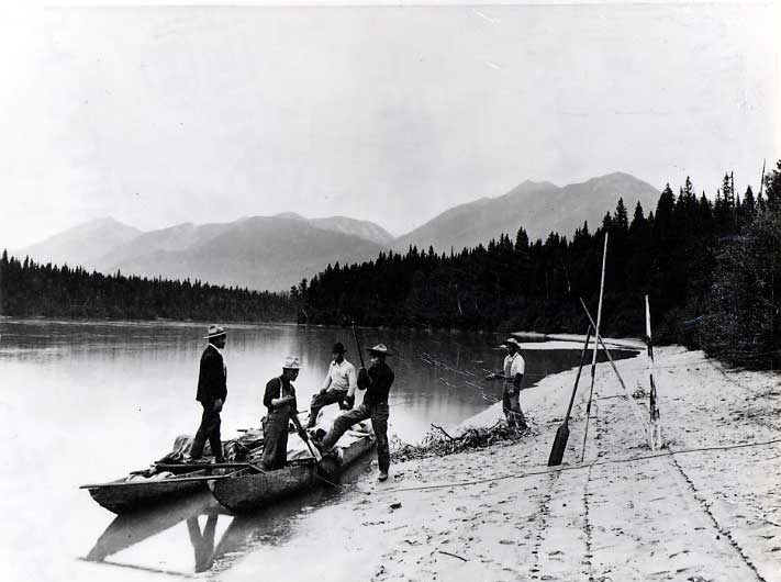 Five men beaching their double canoe.
Original caption: