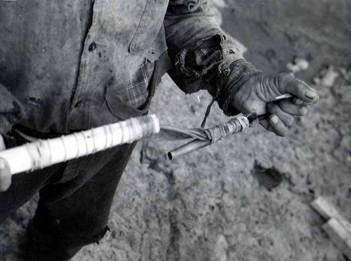 Man holding detatchable fish hook.
Original caption: