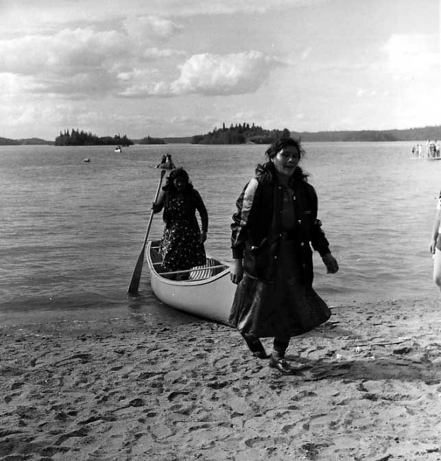 Two Cree women beaching their canoe
