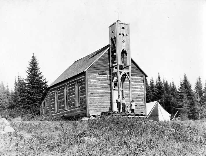 Four Ojibwa children at church steps.
Original caption: