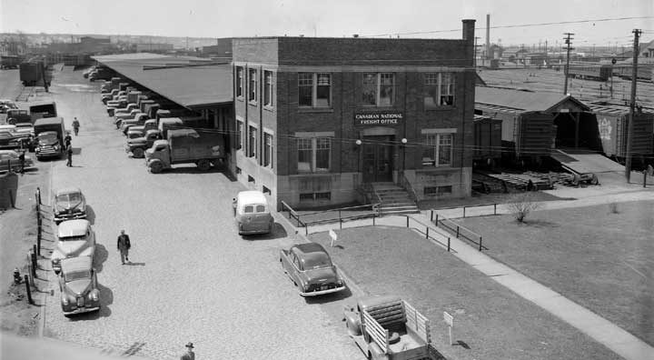 Freight trucks and trains exchanging shipments at Moncton's freight office