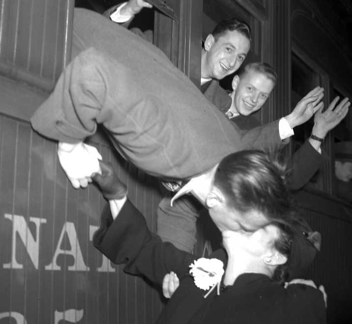 Victor Leblanc kissing his mother Mrs G.A. Leblanc, as he departs Sherbrooke for his first 30 day training camp