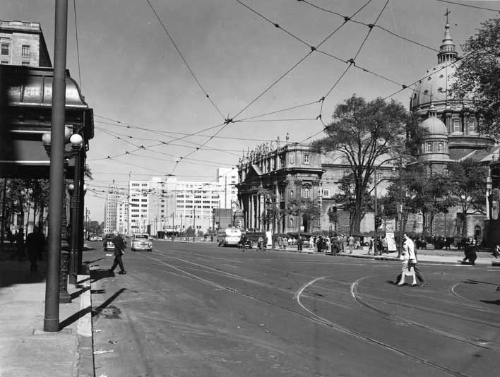 Street scene with Marie-Reine-du-Monde Cathedral, formerly St. James Cathedral, in the background