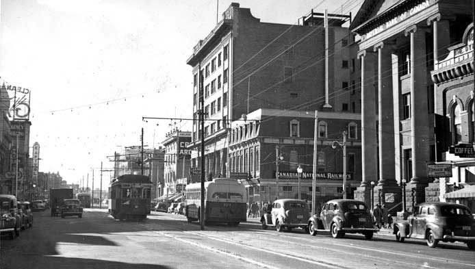A view of Jasper Ave., looking west from 100th St. and a Canadian National Railways building in the foreground