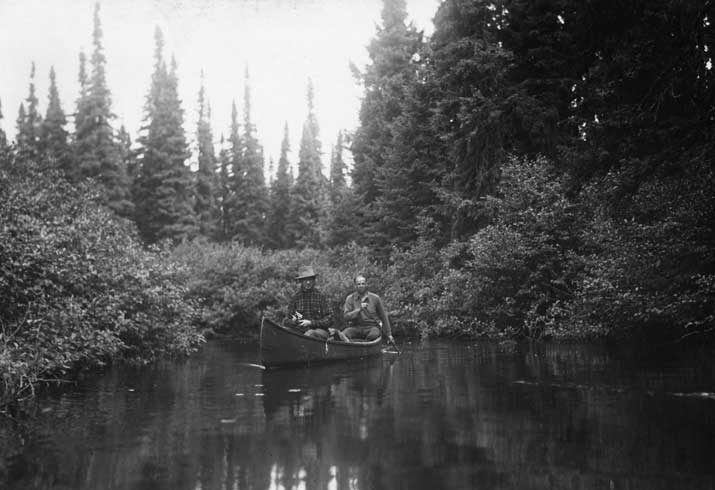 Two men fishing in a canoe