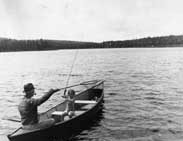 Man and child trout fishing in a boat