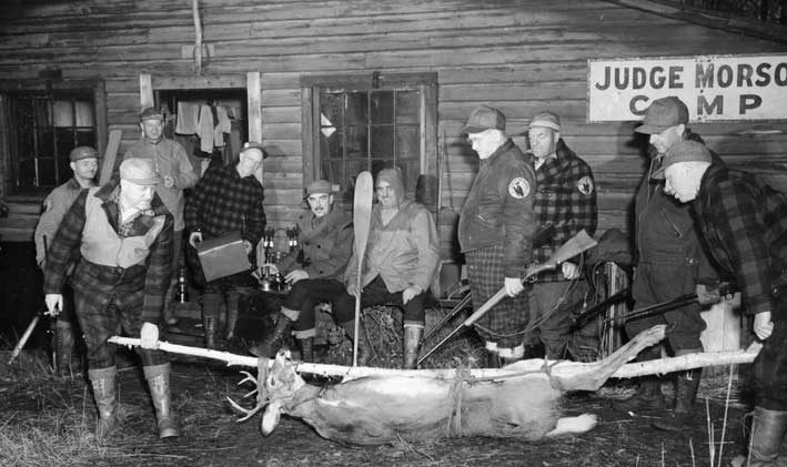 A hunting party examining its kill
